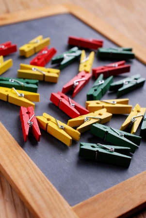 pile of colored pegs on black chalkboard