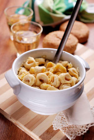 tortellini with cheese in white bowlの写真素材