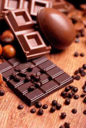 Easter eggs and assorted chocolate on wooden table