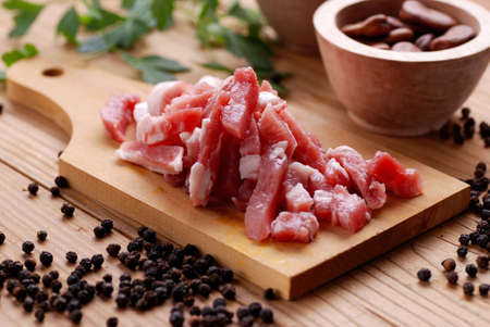 pork bacon on the cutting board, cut into cubesの写真素材