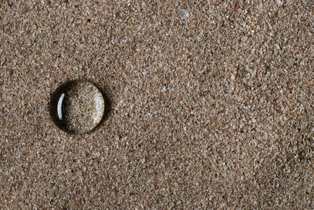 drops of water on the sand photographed close upの写真素材