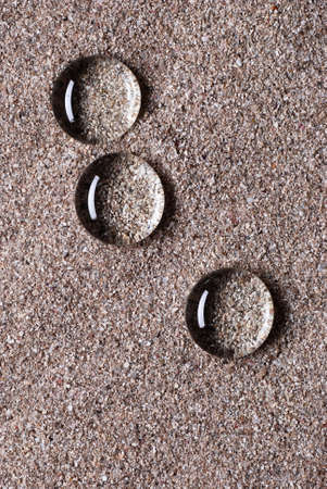 drops of water on the sand photographed close upの写真素材