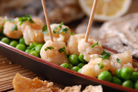 appetizer of fried shrimp and peas on the tableの写真素材