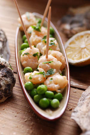 appetizer of fried shrimp and peas on the tableの写真素材