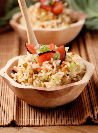 spiced rice with fruit in wooden bowlの写真素材