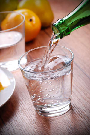 pour fresh water into the glassの写真素材