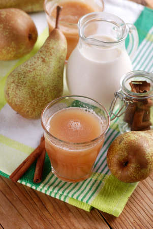 pear smoothie with cinnamon in glass beaker with ingredients aroundの写真素材