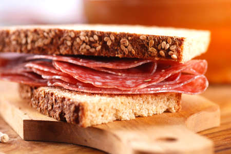 bread and salami on wooden chopping board