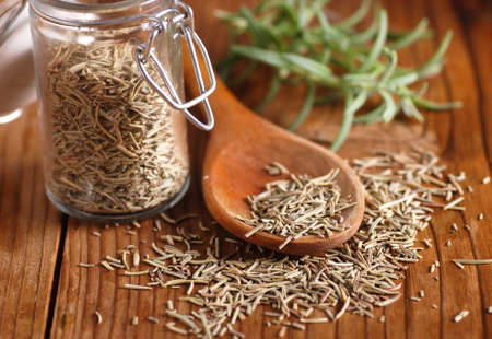 dried rosemary on wooden spoonの写真素材