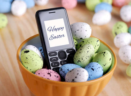 Easter greetings with mobile phoneの写真素材