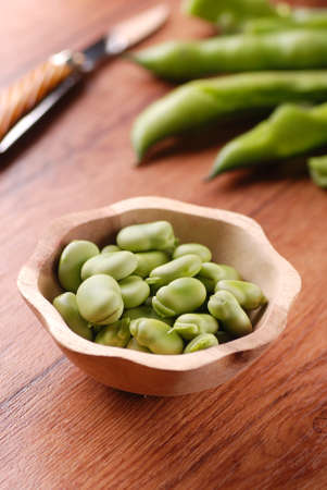 fresh broad beans in the wooden bowlの写真素材