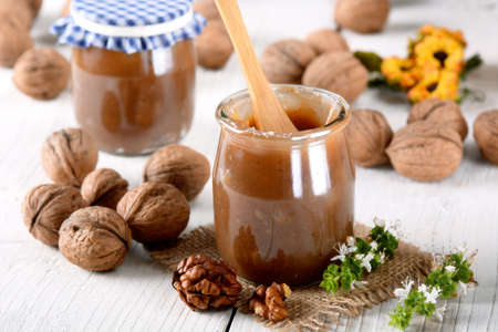walnut jam in glass jar with fruit aroundの写真素材