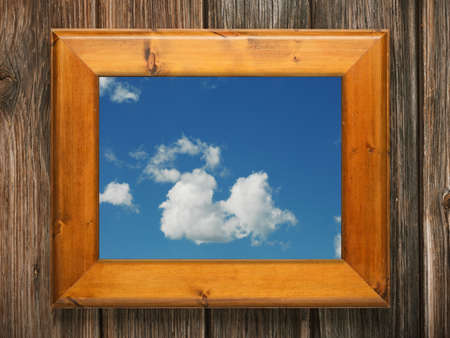 blue sky with clouds in wooden frameの写真素材