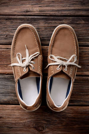 pair of shoes laced on the wooden tableの写真素材