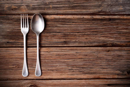 spoon and fork metal on wood tableの写真素材