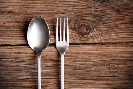 spoon and fork metal on wood tableの写真素材