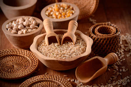 pile of brown rice in wooden bowlの写真素材