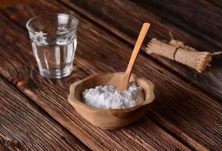 baking soda into the bowl with wooden spoonの写真素材