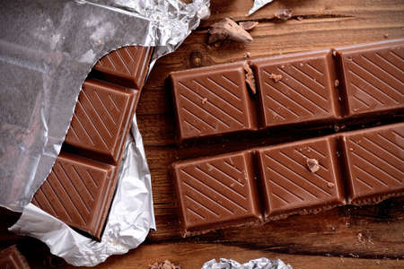 the chocolate bar on the wooden table