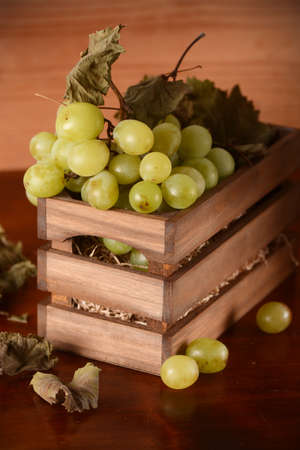 bunch of grapes in a wooden boxの写真素材