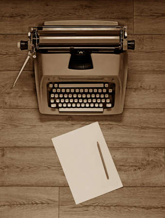 typewriter on wooden table photographed from above