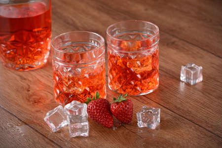 strawberry liqueur on the table with fruit aroundの写真素材