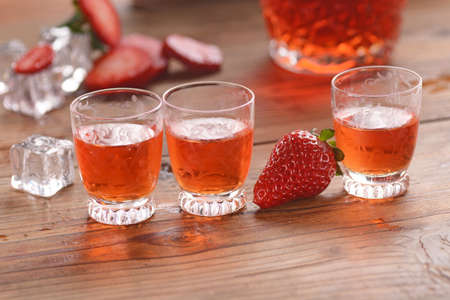 strawberry liqueur on the table with fruit aroundの写真素材