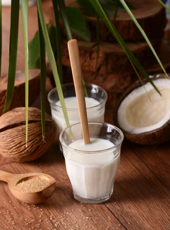 coconut milk in the glass with fruits aroundの写真素材