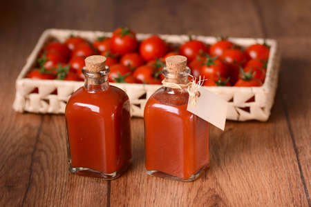 sauce of cherry tomatoes in a glass bottle with ingredients around