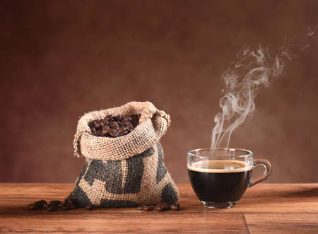 hot steaming coffee on the wooden tableの写真素材