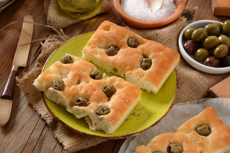 flat bread with green olives on the tableの写真素材