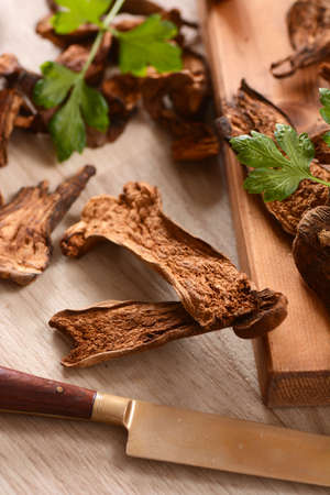 dried porcini mushrooms on wooden chopping boardの写真素材