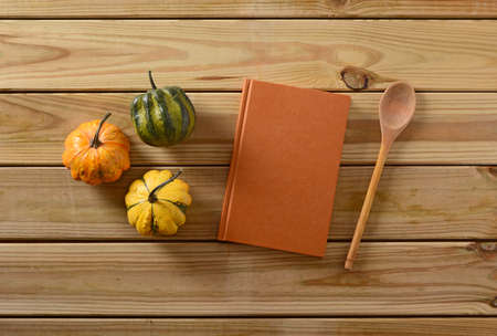 recipe book on the table with three small pumpkinsの写真素材