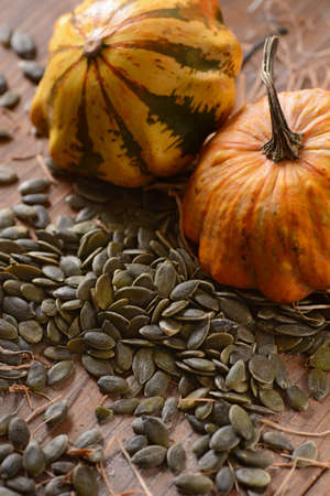 pumpkin seeds on table with vegetables around