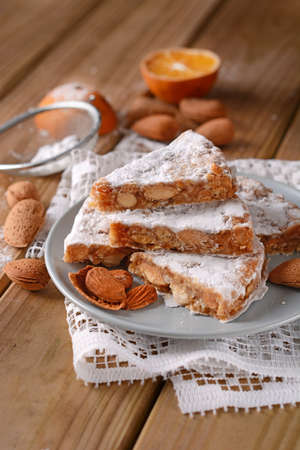 Panforte of Siena - traditional Italian Christmas cake with almonds and orange peel on the tableの写真素材