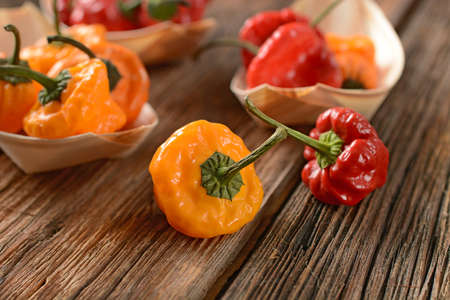 allspice red and yellow in the wooden bowl - closeup