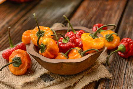 allspice red and yellow in the wooden bowl.