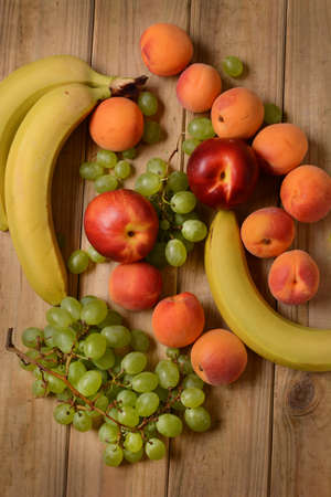 Assorted fruit on wooden table - closeup