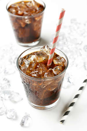 Cola with crushed ice in the glass on white background - closeupの写真素材