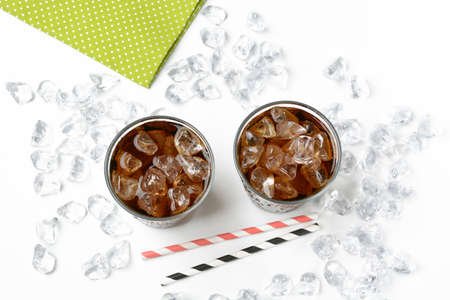 Cola with crushed ice in the glass on white background - closeupの写真素材