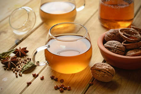 Herbal tea with walnuts and ingredients around - closeupの写真素材