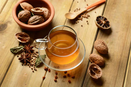 Herbal tea with walnuts and ingredients around - closeupの写真素材