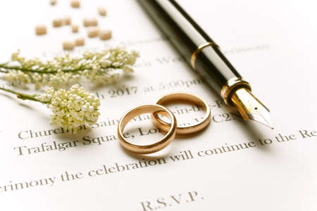Wedding invitation with gold rings - closeupの写真素材