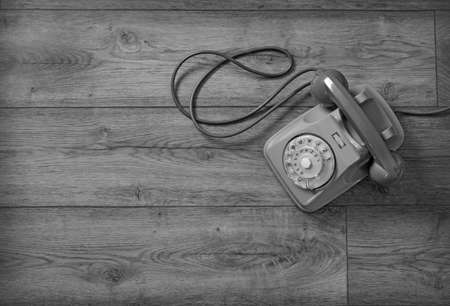 retro phone isolated on wooden table - closeupの写真素材