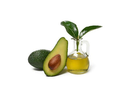 avocado oil with fruits around - isolated on white background - closeup