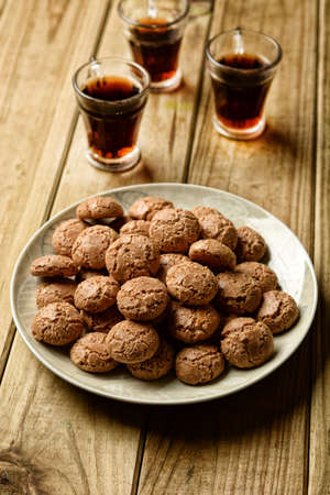amaretti cookies with liqueur beside - traditional Italian pastry products - closeupの写真素材