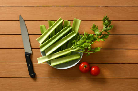 celery cut with tomato and knife beside - closeupの写真素材