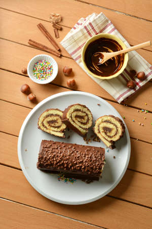 Chocolate roll cake with hazelnut cream filling - closeup