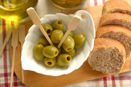 pitted olives in the white bowl - closeupの写真素材