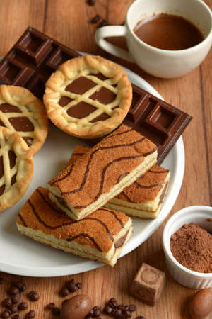 assorted chocolate foods in the wooden table - closeup